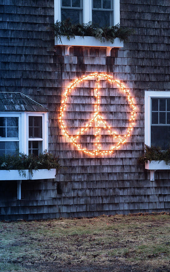 Peace Symbol Made From Fairy Lights On Shingle Facade Of House Photograph by Eising Studio