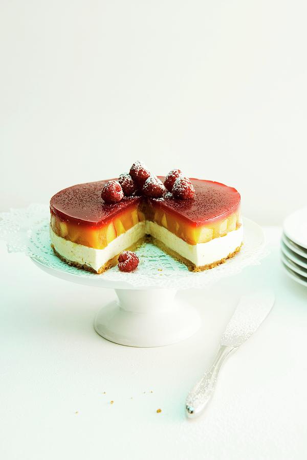 Peach Melba Cake With Raspberry Jelly On A Cake Stand Photograph by Michael Wissing