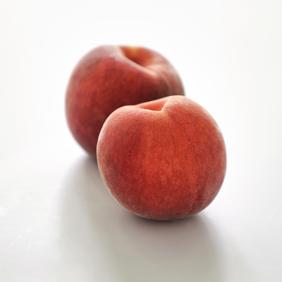 Peaches On A White Background Photograph by Carnet