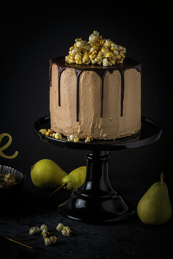 Pear And Nougat Pie With Caramel Popcorn On A Black Cake Stand Photograph by Christian Kutschka