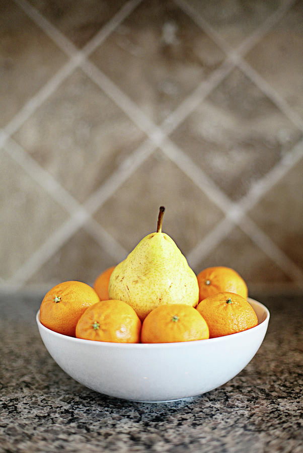 Pear Surrounded By Oranges In White Bowl Photograph by Stephanie Mull Photography