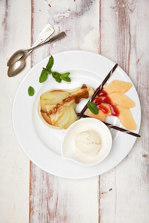 Pear Tart With Melon And Vanilla Ice Cream Photograph by Claudia Timmann