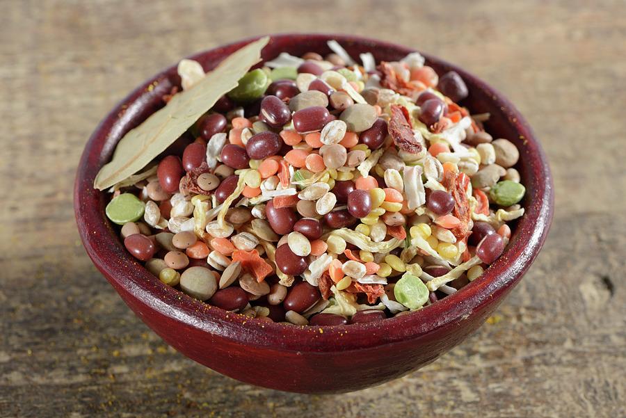 Pearl Barley, Green Lentils, Red Lentils, Aduki Beans, Mung Beans, Soup Vegetables, Bay Leaf, Onions And Tomato Flakes In A Ceramic Bowl Photograph by Diez, Otmar