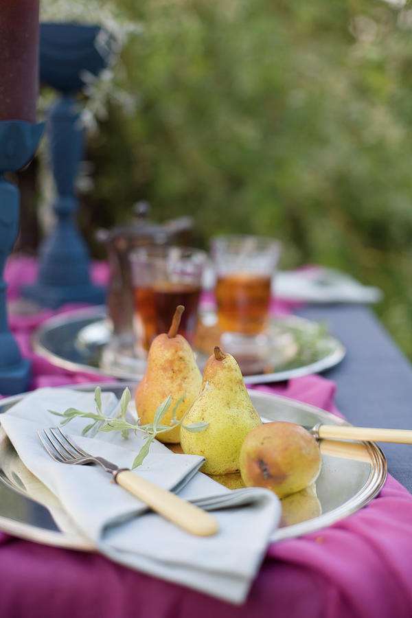 Pears And Tea On Set Table In Garden Photograph by Alicja Koll