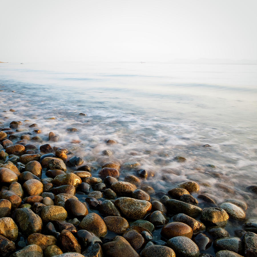 Pebble Rocks On Beach Photograph by Visualcommunications