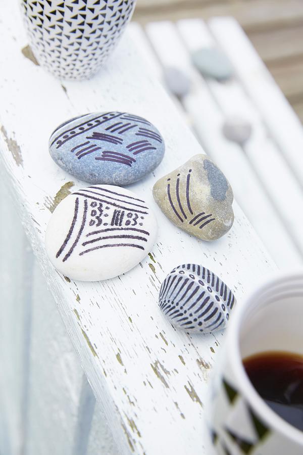 Pebbles Painted With Patterns Of Stripes Photograph by Greenhaus Press