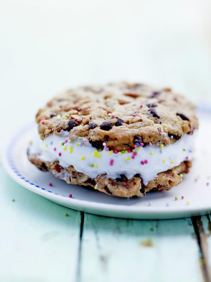 Pecan And Chocolate Chip Cookie Sandwich With Frozen Yoghurt And Sugar Pearls Photograph by Amiel