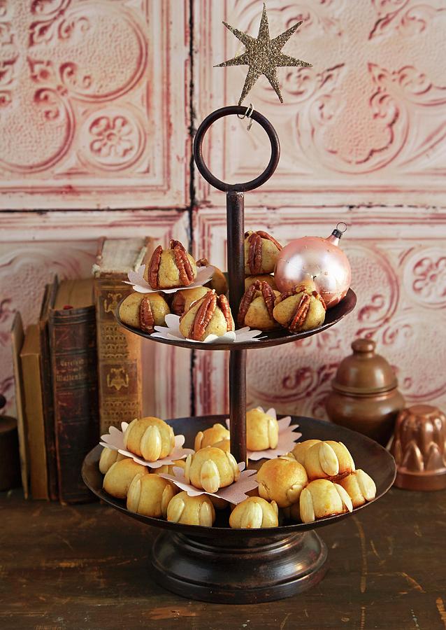 Pecanmnnchen And Bethmnnchen pastry Made From Marzipan With Pecan Nuts And Almonds, Powdered Sugar, Rosewater, Flour And Egg On A Cake Stand Photograph by Jalag / Julia Hoersch