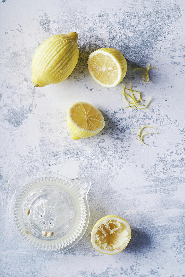 Peeled Lemons And Juicer, Light Background Photograph by Arjan Smalen Photography