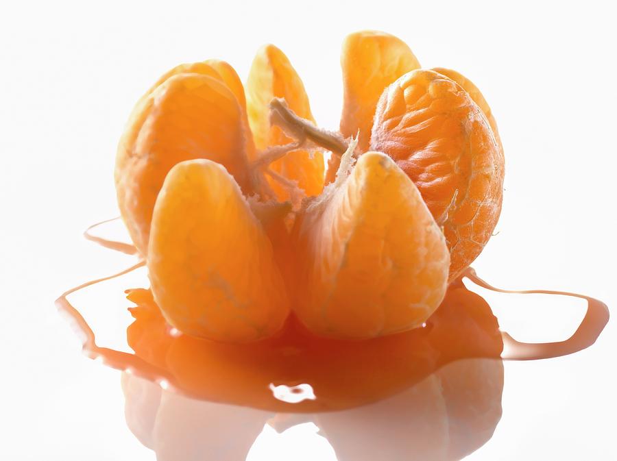Peeled Open Clementine With Juice Photograph by Studio