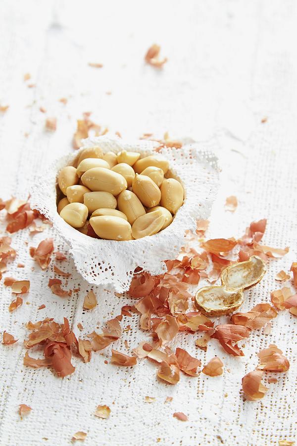 Peeled Peanuts In A Bowl With The Shells Next To It Photograph by Miriam Rapado