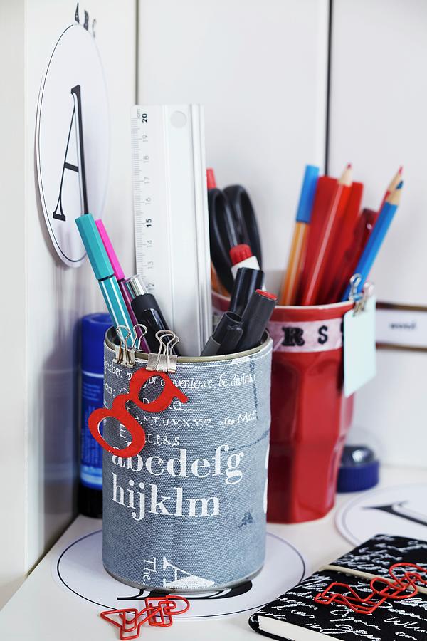 Pen Holders With Decoupage Alphabet Design On Desk Photograph by Franziska Taube