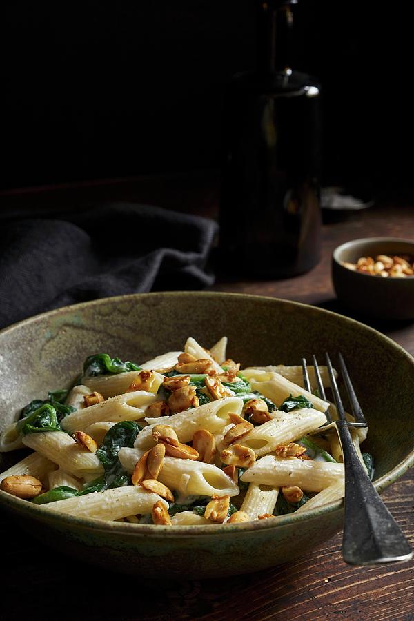Penne With Spinach And Caramelised Peanuts In Goats Cheese Sauce Photograph by Ulrike Emmert