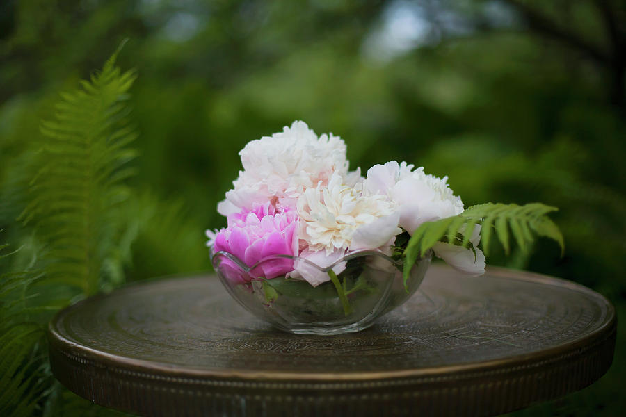 Peonies In Glass Bowl On Table In Enchanting Garden Photograph by Alicja Koll