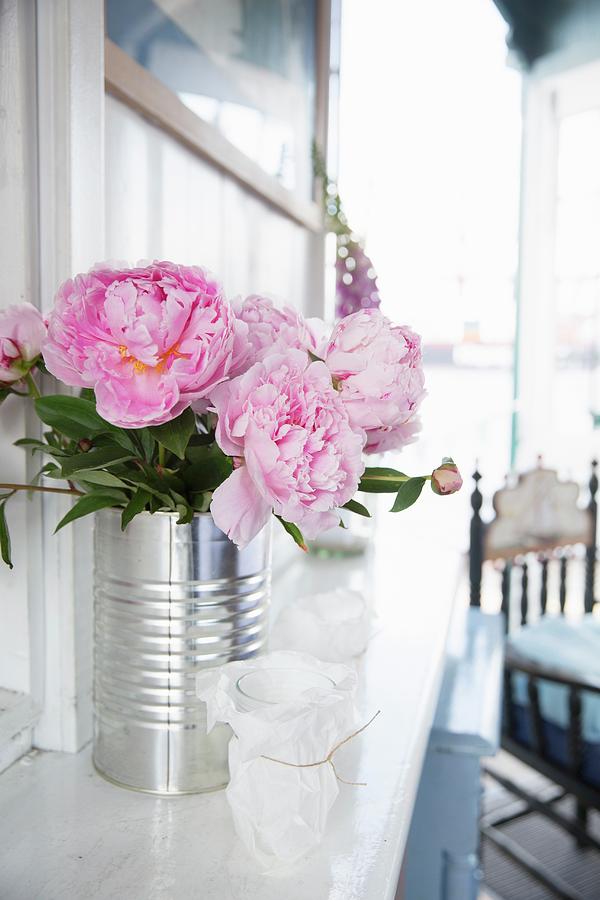 Peonies In Tin Can Against Wooden Wall Photograph by Claudia Timmann