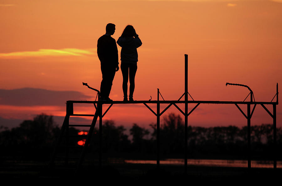 Nature Photograph - People Enjoy Sunset in the Town of Turov by Vasily Fedosenko