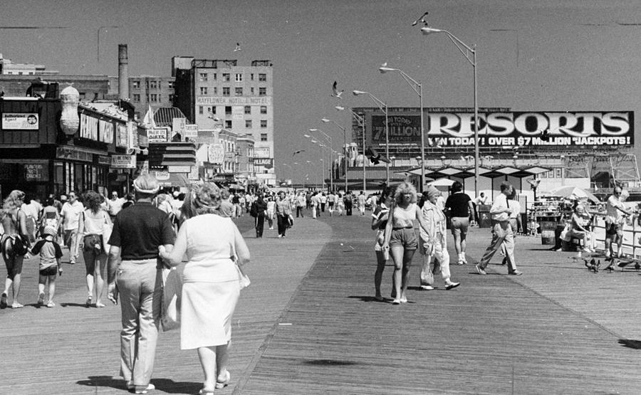 People Walk Along The Boardwalk In Photograph by New York Daily News Archive