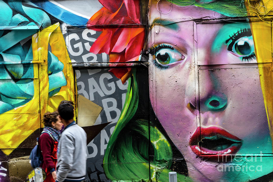 People Walking Past Graffiti Face Photograph by Tim Bird
