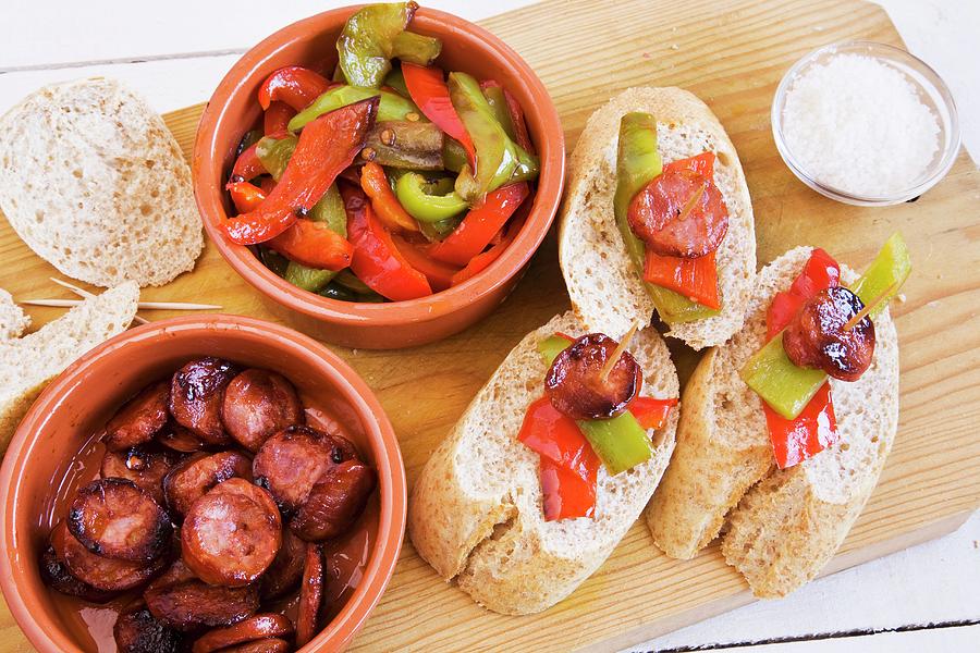 Peppers With Chorizo And Bread On A Wooden Board spain Photograph by Dudley Wood