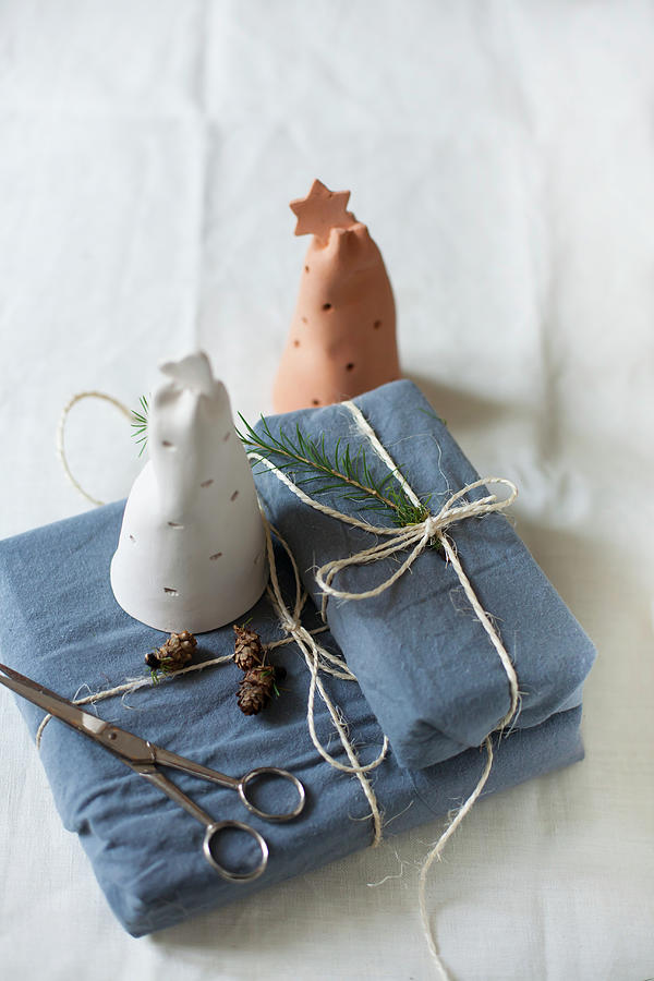 Perforated Pottery Bells On Gifts Wrapped In Fabric Photograph by Alicja Koll