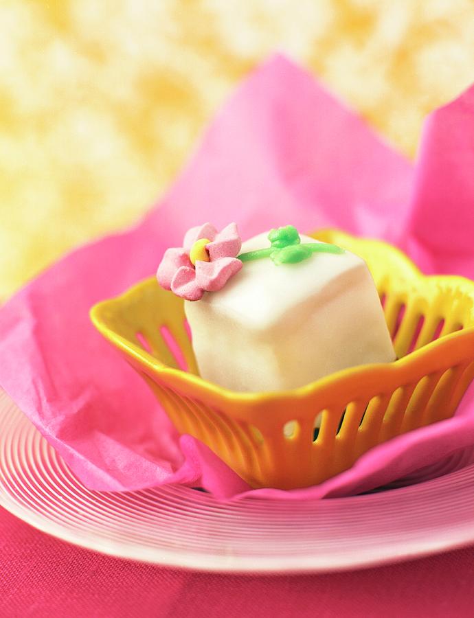 Petit Four In A Yellow Dish On Pink Paper Photograph by Garten, Peter