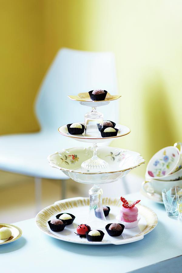 Petit Fours And Pralines On A Homemade Cake Stand Photograph by Jalag / Janne Peters