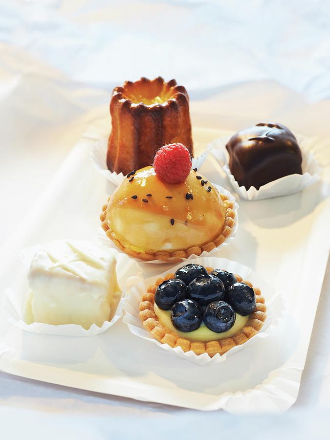 Blondie Photograph - Petit Fours, Cannele, Tartlets With Lemon And Mascarpone Cream And Blueberries, Mini Cheesecakes With Raspberries by Oliver Lippert