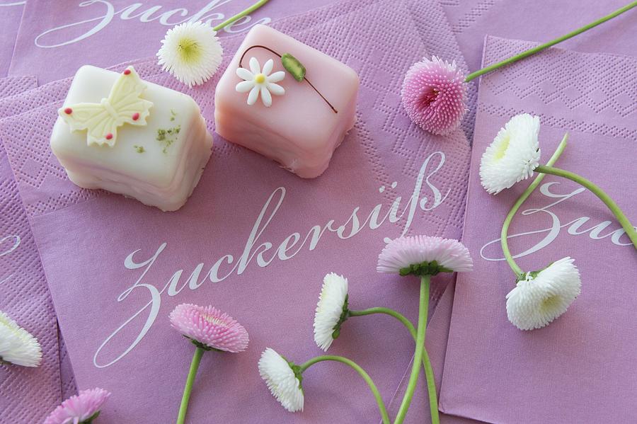 Petit Fours With Bellis On Paper Napkins Photograph by Martina Schindler