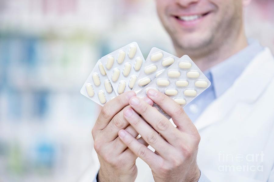 Pharmacist Holding Blister Packs Photograph by Science Photo Library