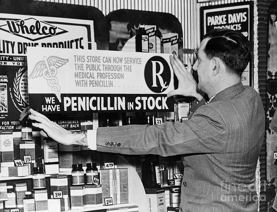 Pharmacist Placing Sign In Store Photograph by Bettmann