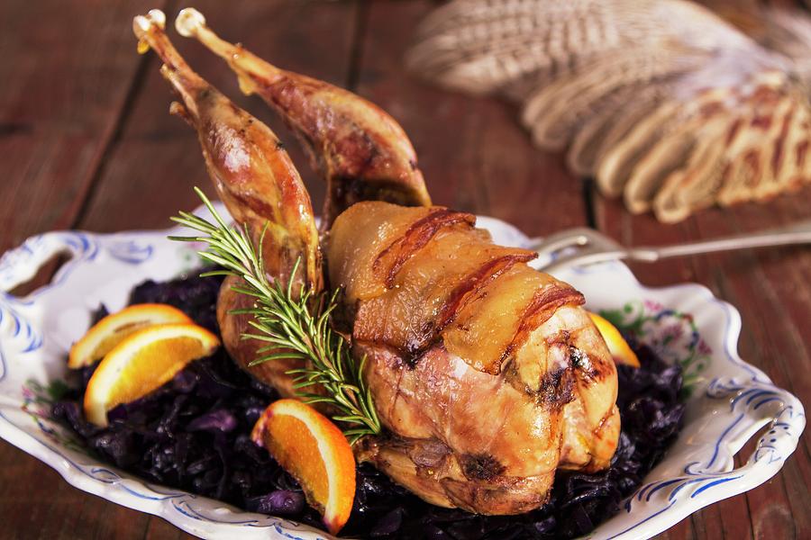 Pheasant Wrapped In Bacon With Oranges And Red Cabbage Photograph by Monika Halmos