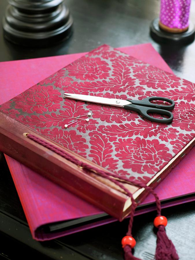 Photo Album With Red Flora Pattern And Scissors Photograph by Per Magnus Persson