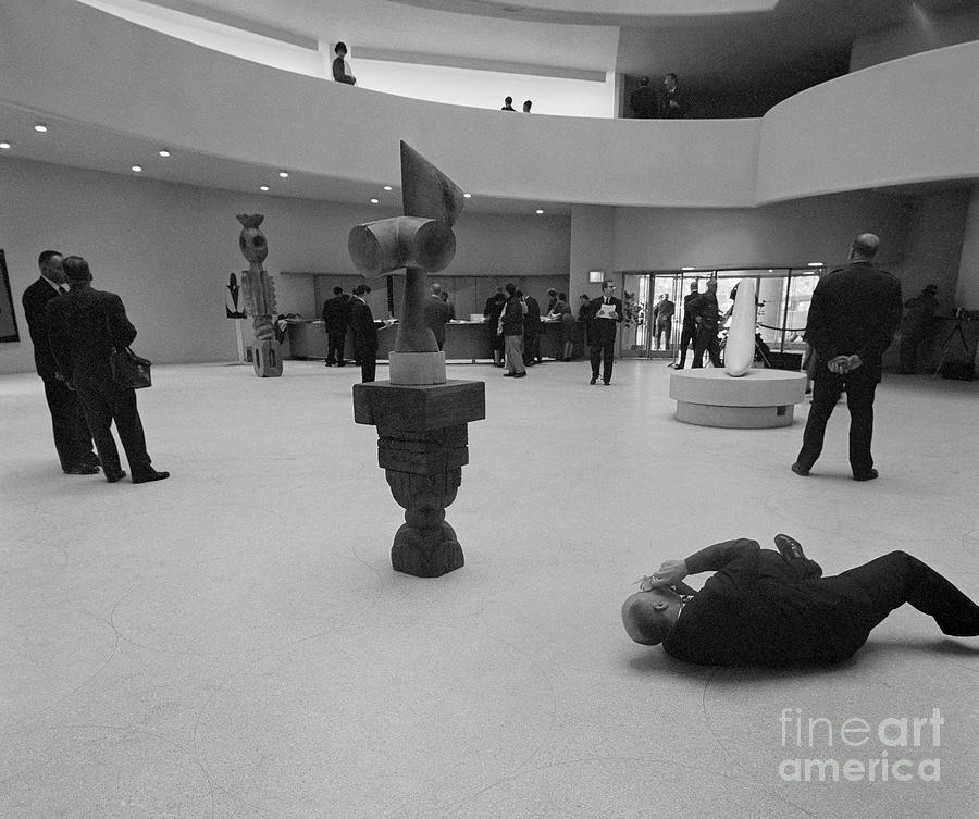 Photographer Lying On Floor And Taking Photograph by Bettmann Photographer Lying On Floor And Taking Photograph by Bettmann