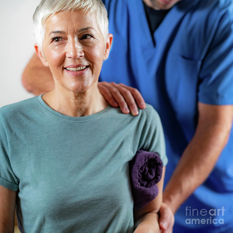 Physical Therapist Examining Patients Arm Photograph by Microgen Images/science Photo Library