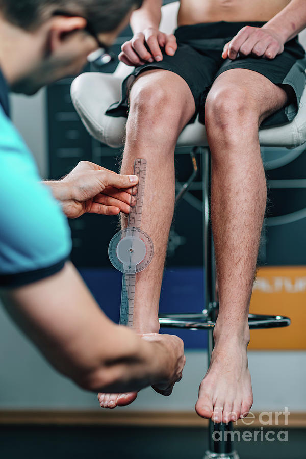 Physical Therapist Measuring Teenage Boys Shin Photograph by Microgen Images/science Photo Library