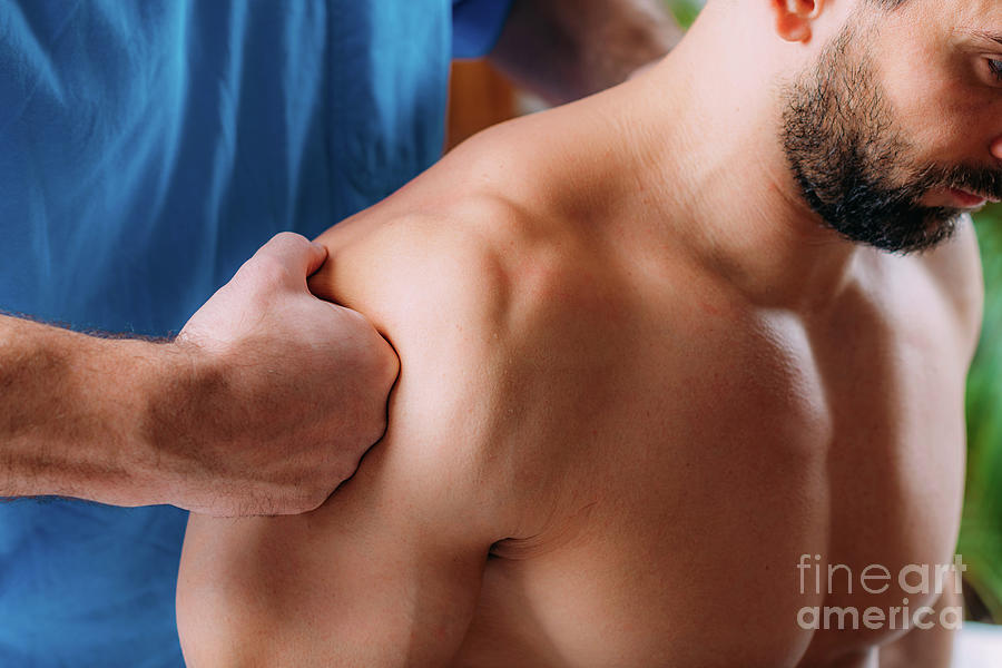 Physiotherapist Massaging Athletes Shoulder Photograph by Microgen Images/science Photo Library