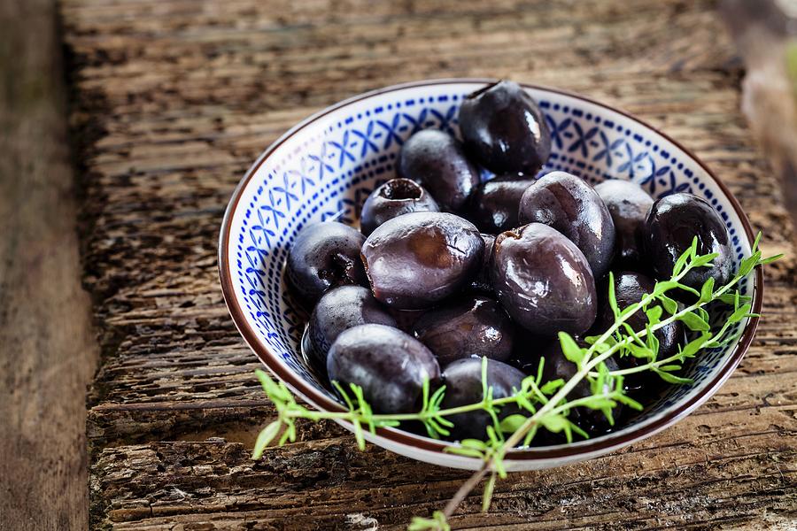 Pickled Black Olives With A Sprig Of Thyme Photograph by Susan Brooks-dammann