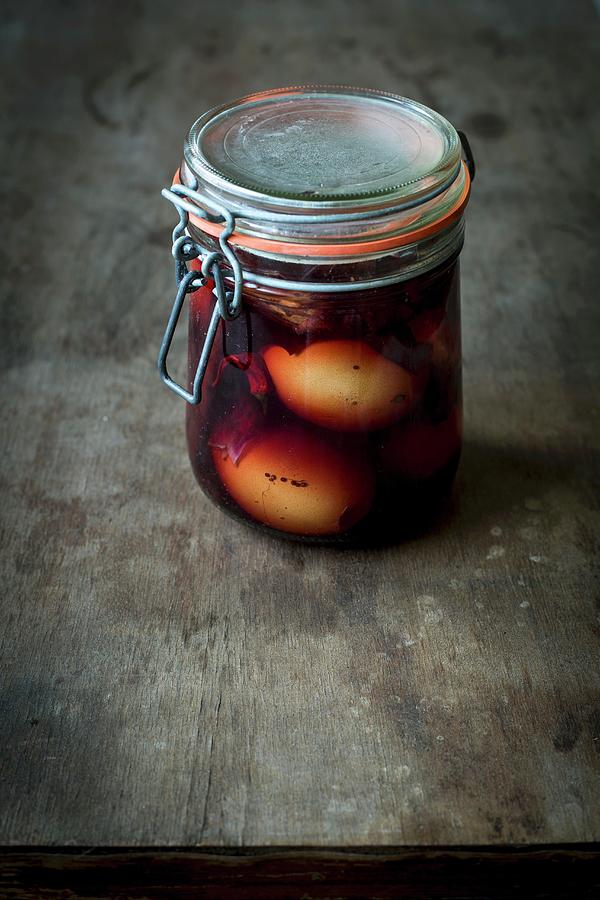 Pickled Eggs With Onion Skins And A Spiced Liquid In A Jar On A Wooden Table Photograph by Food With A View