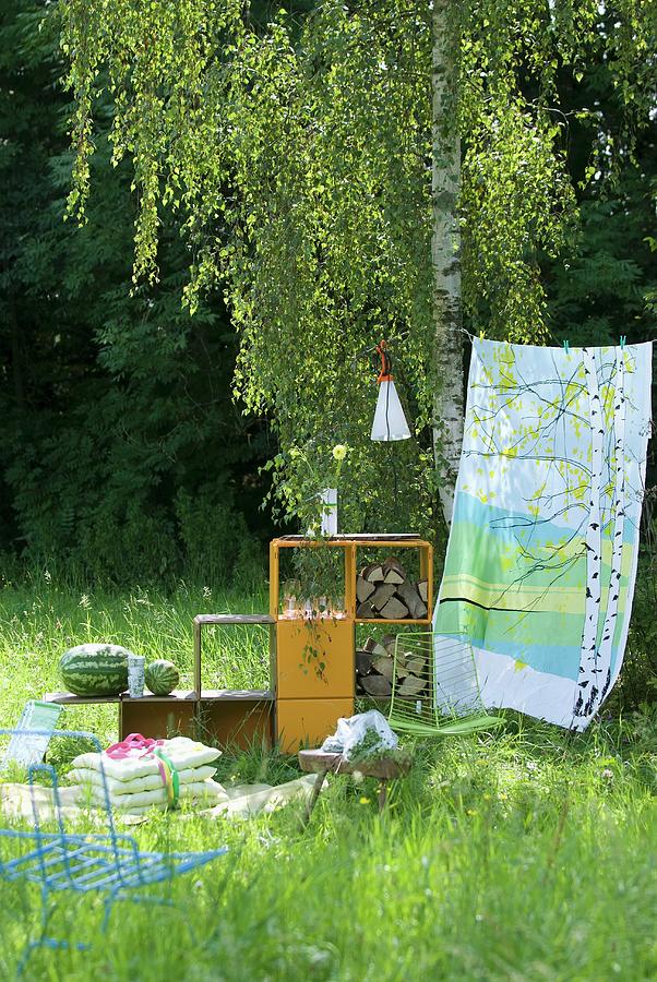 Picnic Blanket, Cushions, Shelving Holding Water Melons And Logs And Colourful Cloth Hung As A Windbreak Photograph by Matteo Manduzio