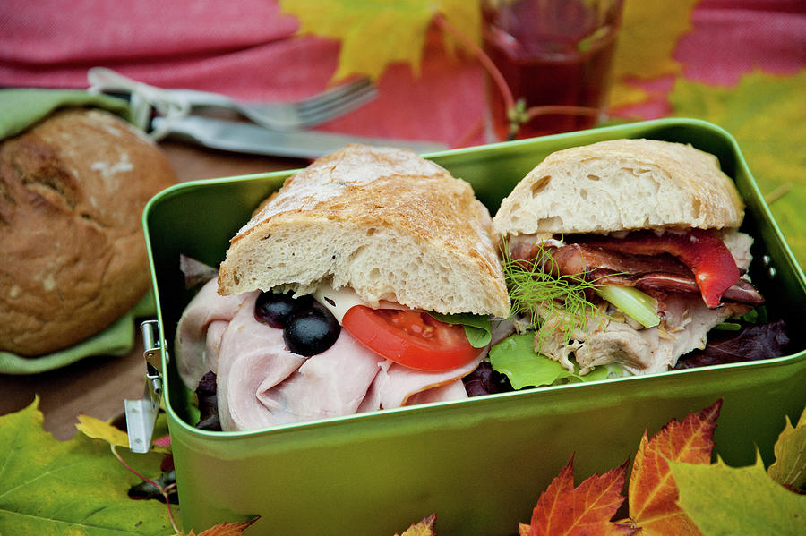 Picnic Lunchbox With Ham, Olives And Tomato In Bun Photograph by Jalag / Brbel Miebach
