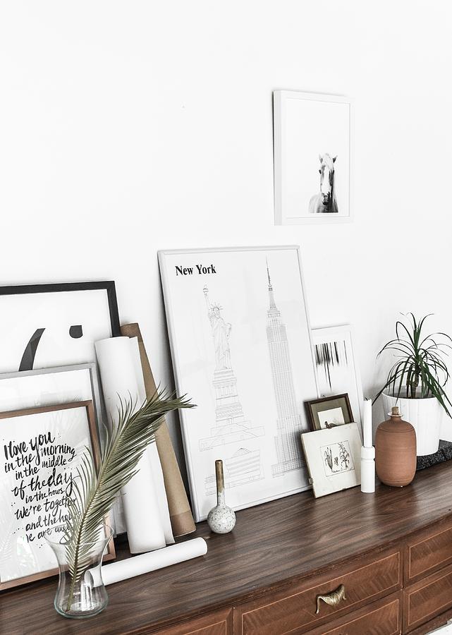 Pictures And Framed Graphic Artworks On Top Of Old Chest Of Drawers Photograph by Agata Dimmich
