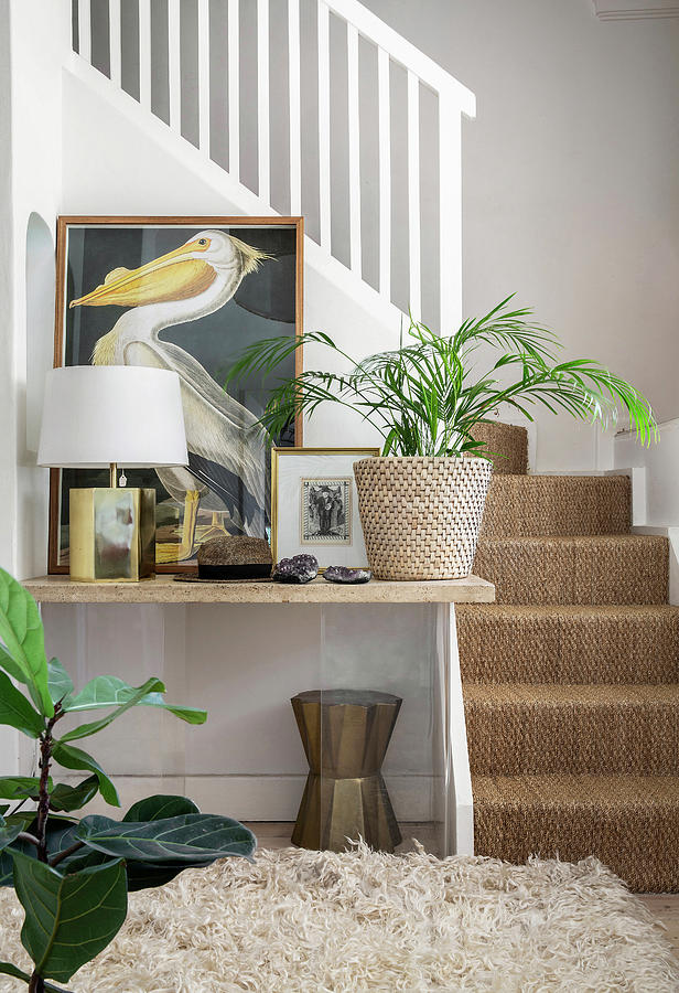 Pictures, Lamp And Houseplant On Table Next To Foot Of Stairs Photograph by Great Stock!