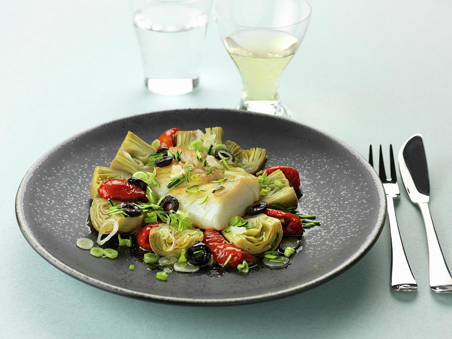 Piece Of Cod With Artichokes, Confit Tomatoes And Black Olives Photograph by Gelberger