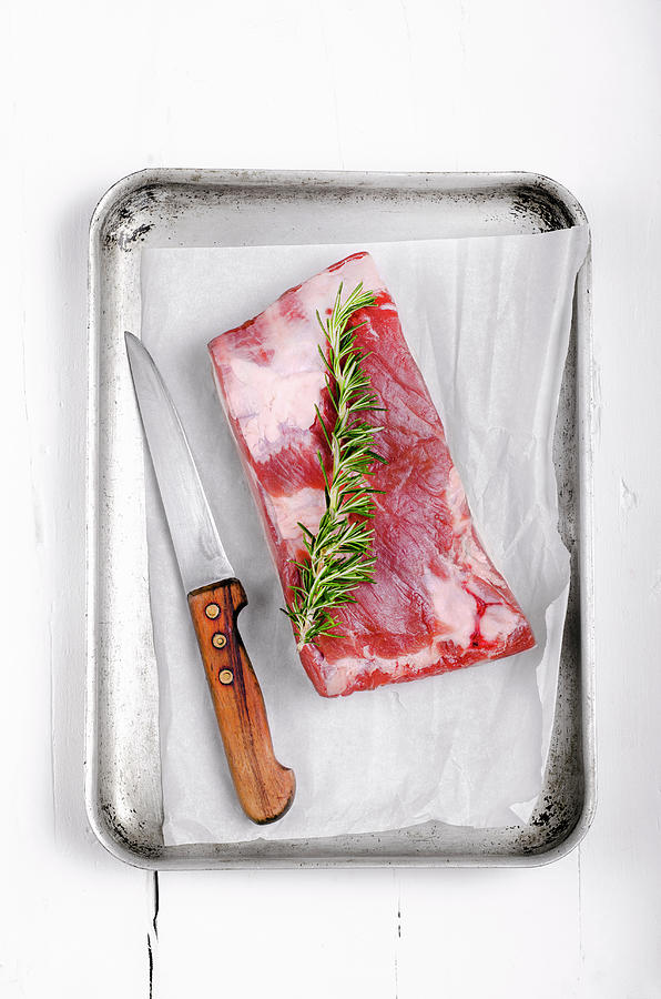 Piece Of Pork Belly With A Sprig Of Rosemary In An Metal Roasting Tray Photograph by Jamie Watson