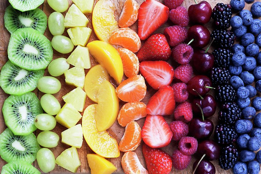 Pieces Of Fruit Laid Out In A Rainbow Photograph by Victoria Firmston