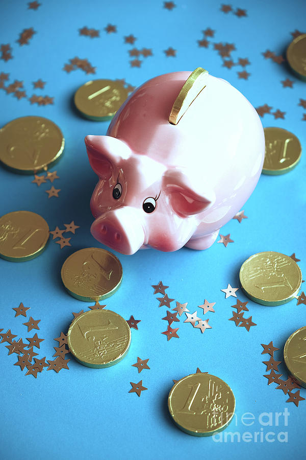 Piggy bank on the background with the  chocoladen coins Photograph by Marina Usmanskaya