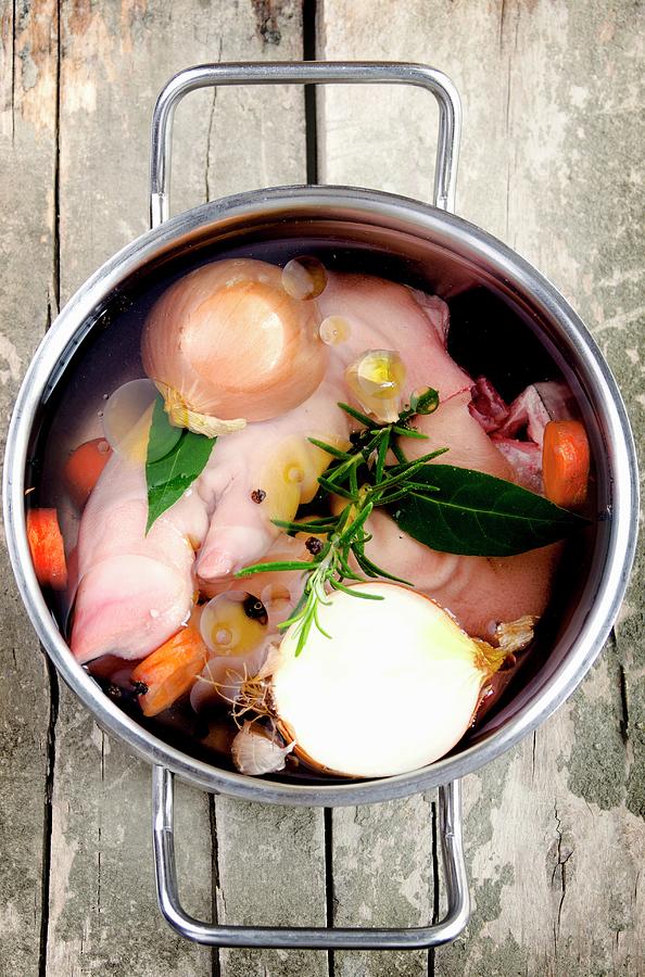 Pig's Trotters In A Pot With Onions, Bay Leaves, Carrots, Rosemary ...