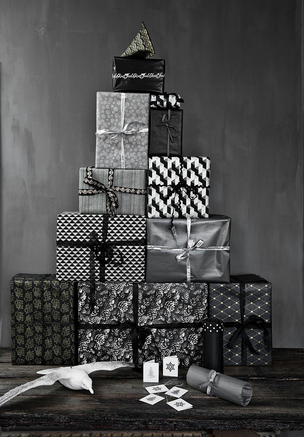 Pile Of Gifts Wrapped In Monochrome Paper And Seagull Figurine On Wooden Table Photograph by Lykke Foged & Morten Holtum