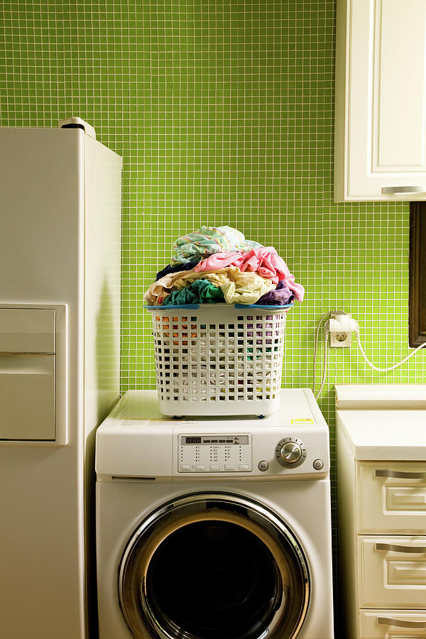 Pile Of Laundry On Washing Machine Photograph by Jae Rew
