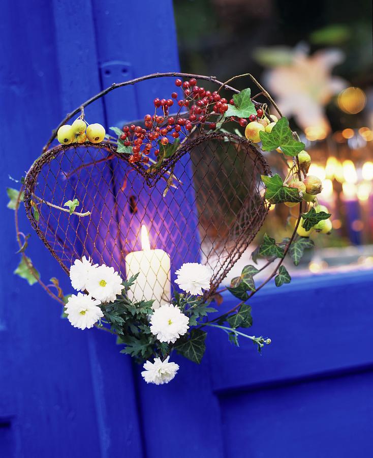 Pillar Candle In Wire Love-heart Decorated With Ivy, Branches And Berries Decorating Summer Garden Photograph by Matteo Manduzio